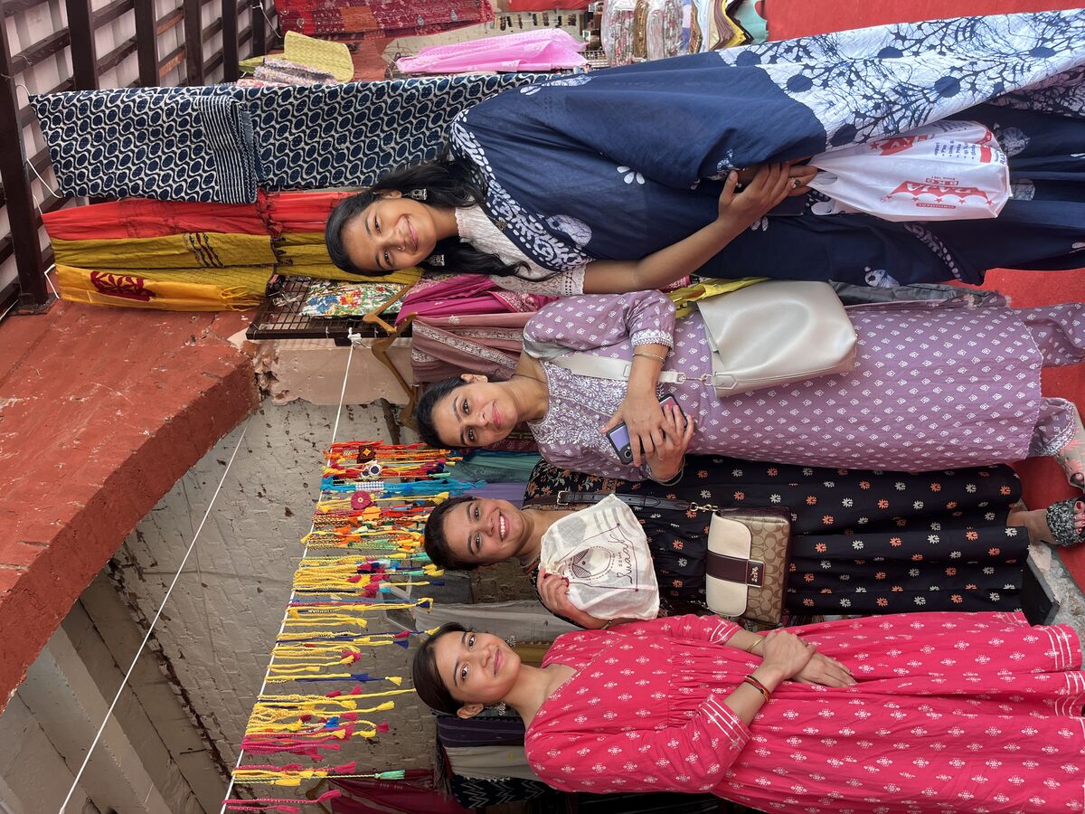 Women artisans showcasing colorful textiles and crafts